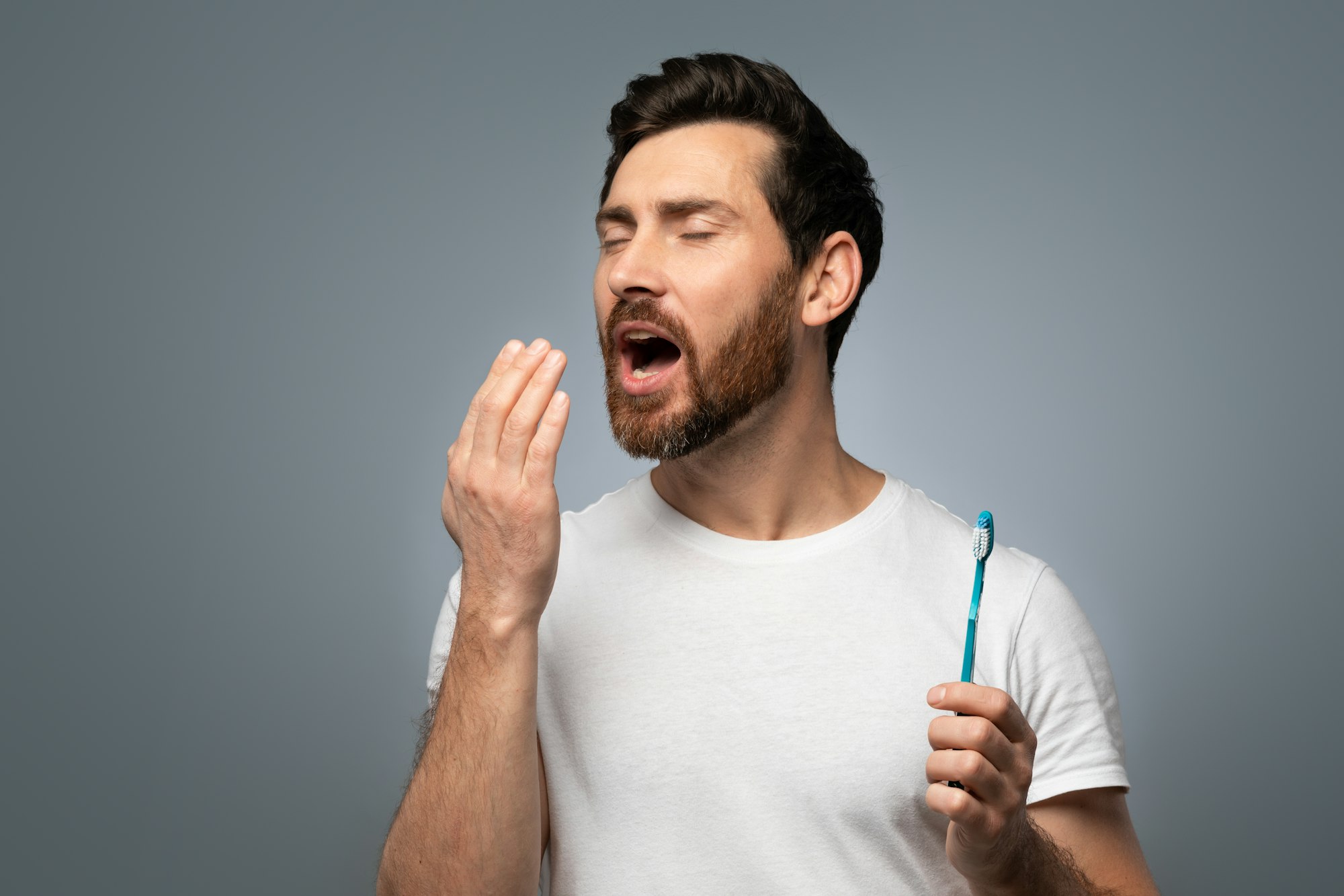 Man checking his breath, representing the concern and treatment for Bad Breath at Schlueter Periodontics.