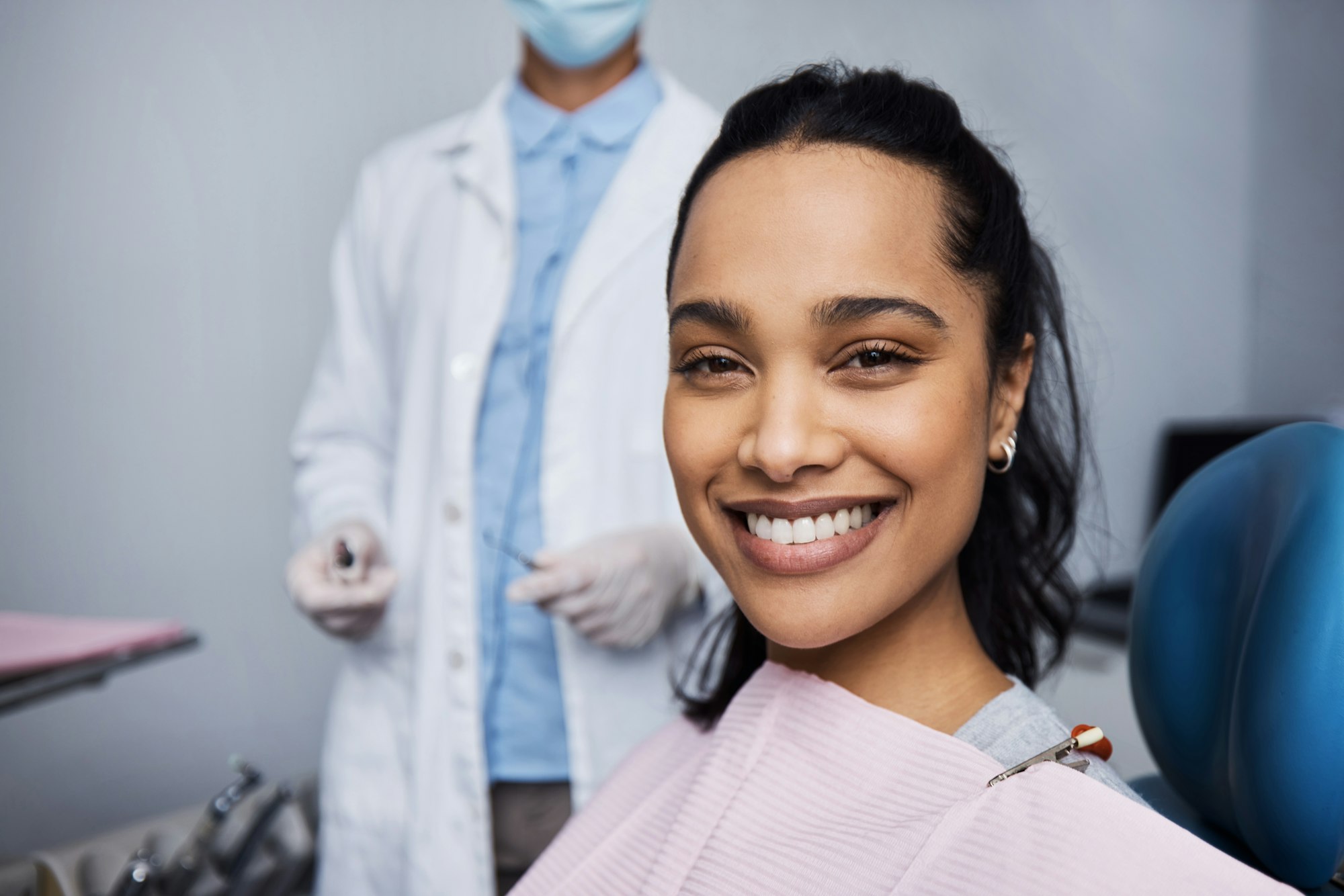 Smiling woman undergoing dental work, demonstrating the process and patient satisfaction with Wilkodontics at Schlueter Periodontics.